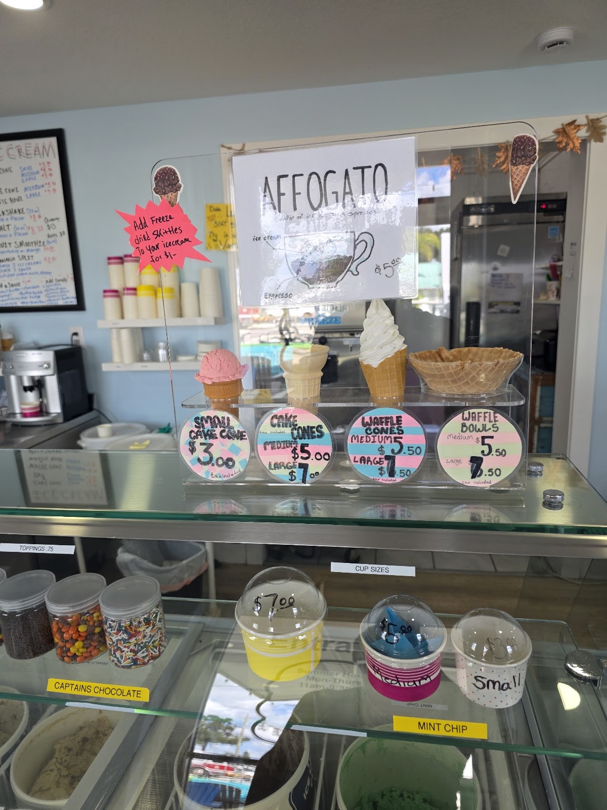 The cone and cup display at Pinecraft showing cake cones, waffle cones and waffle bowls with prices